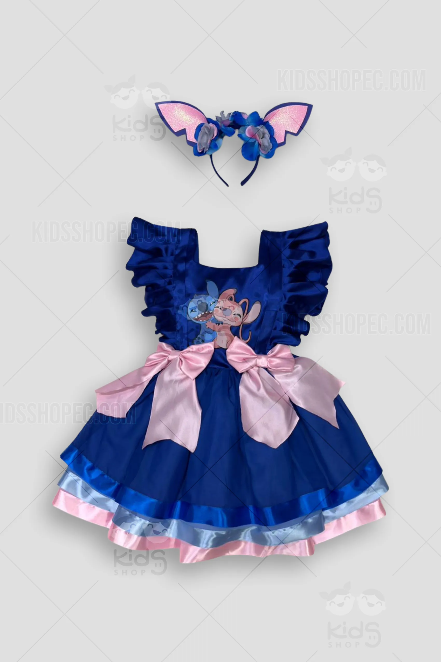 Conjunto artesanal de disfraz de Stitch para bebé niña en color azul y rosa brillante. Incluye vestido de tul multicapa con aplique de cara de Stitch y flor rosa, diadema de orejas estructuradas con lazo y camiseta blanca con orejas de Stitch en las mangas. Hecho a medida por Kids Shop EC en Quito, Ecuador.